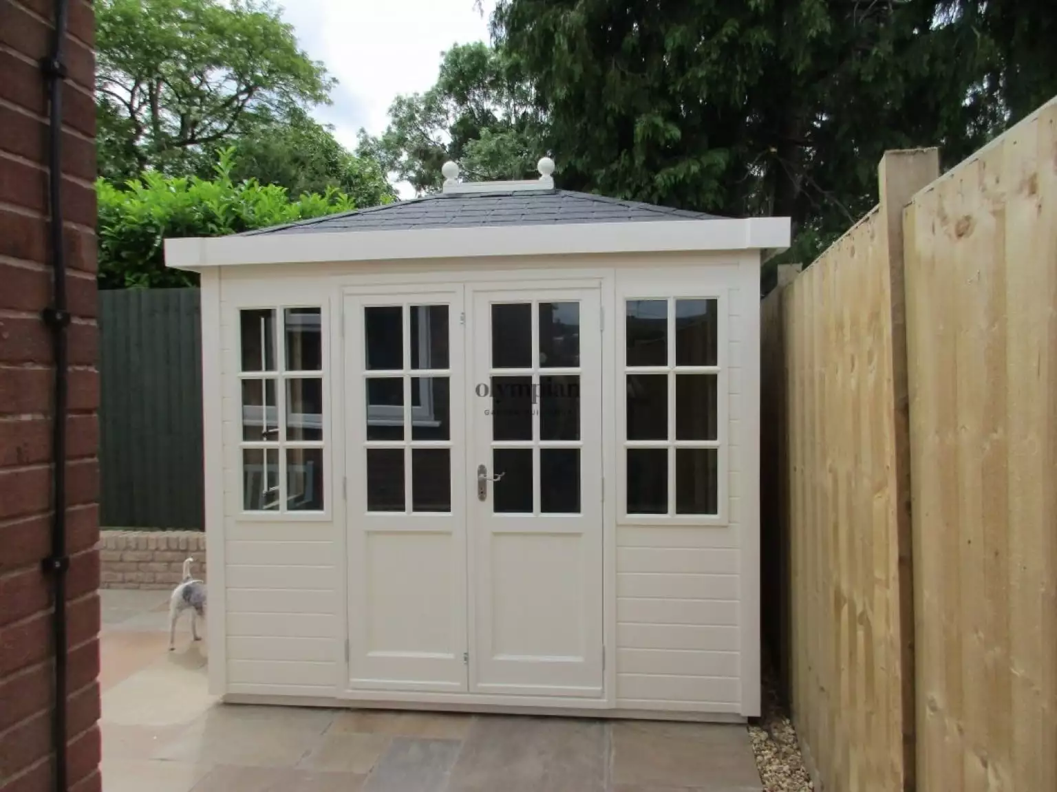 Painted hipped roof summerhouse with felt shingles