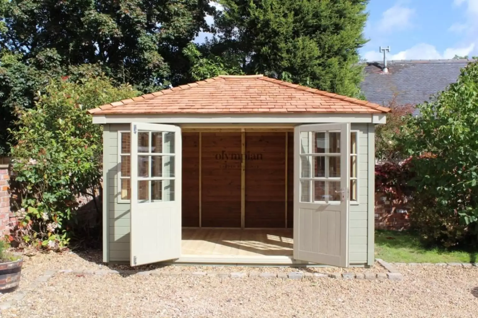 Painted hipped roof summerhouse with cedar shingles