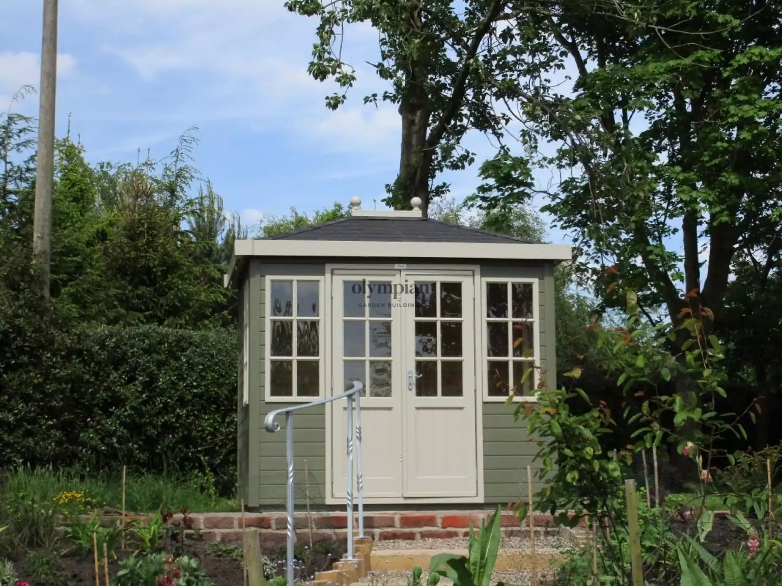 Painted hipped roof summerhouse with felt shingles