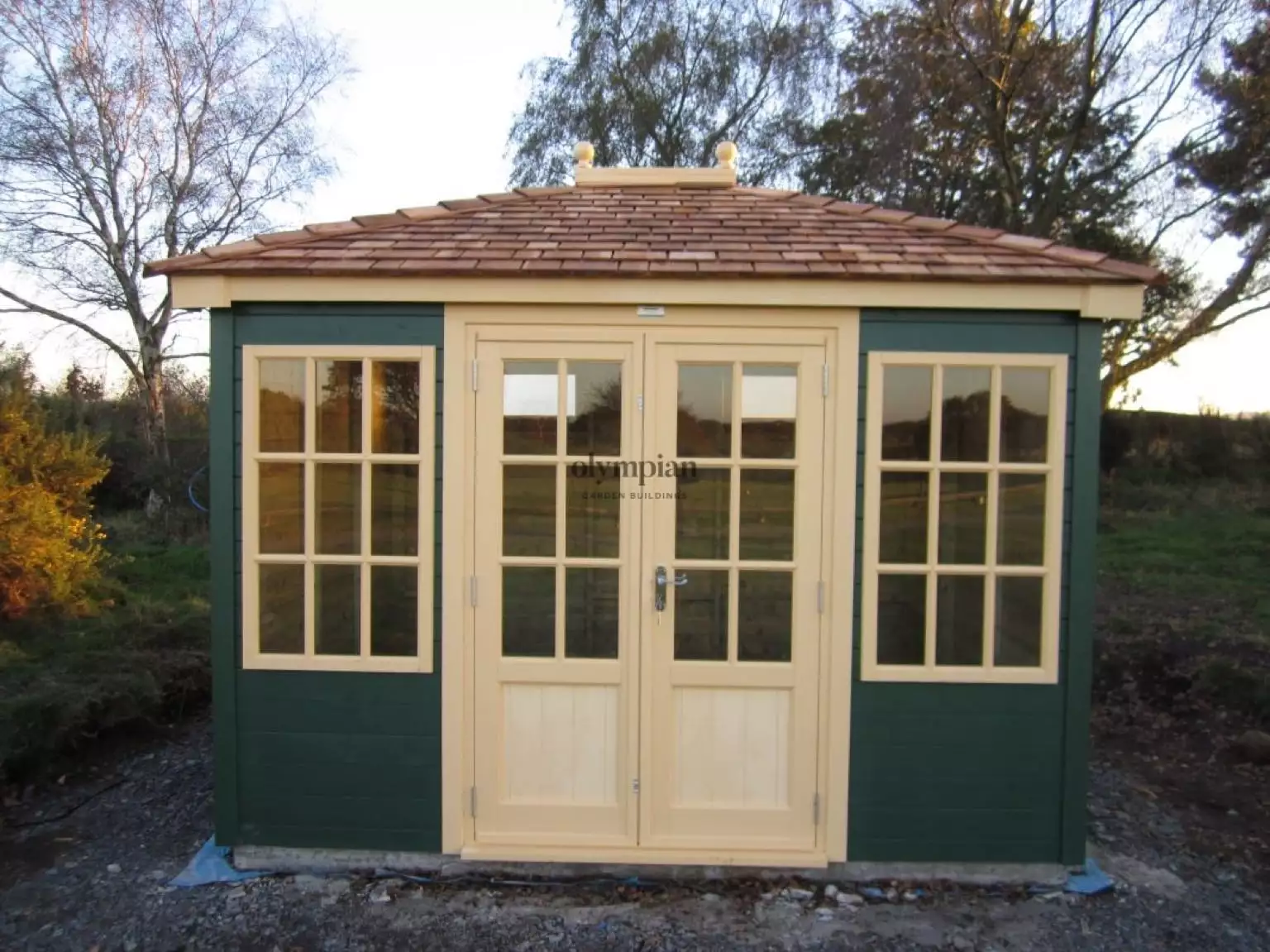 Hipped roof summerhouse with cedar shingles