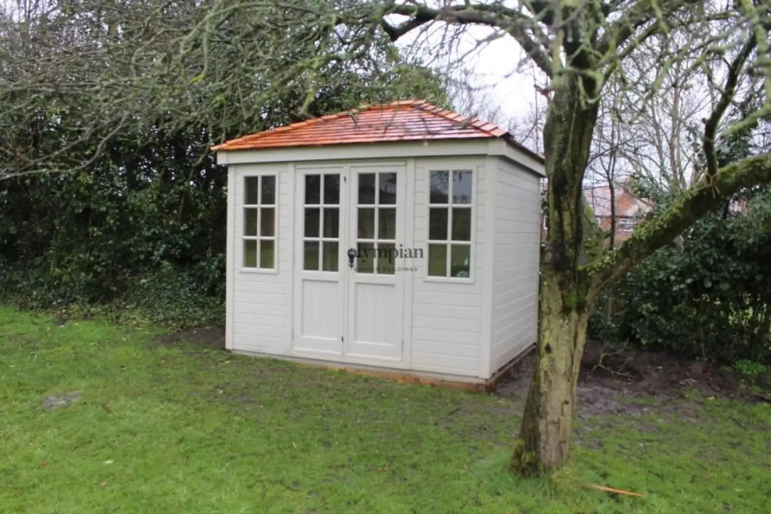 Hipped roof summerhouse with cedar shingles
